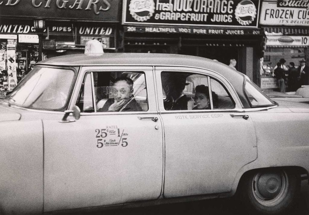 Diane Arbus. Taxicab driver at the wheel with two passengers, N.Y.C. 1956.